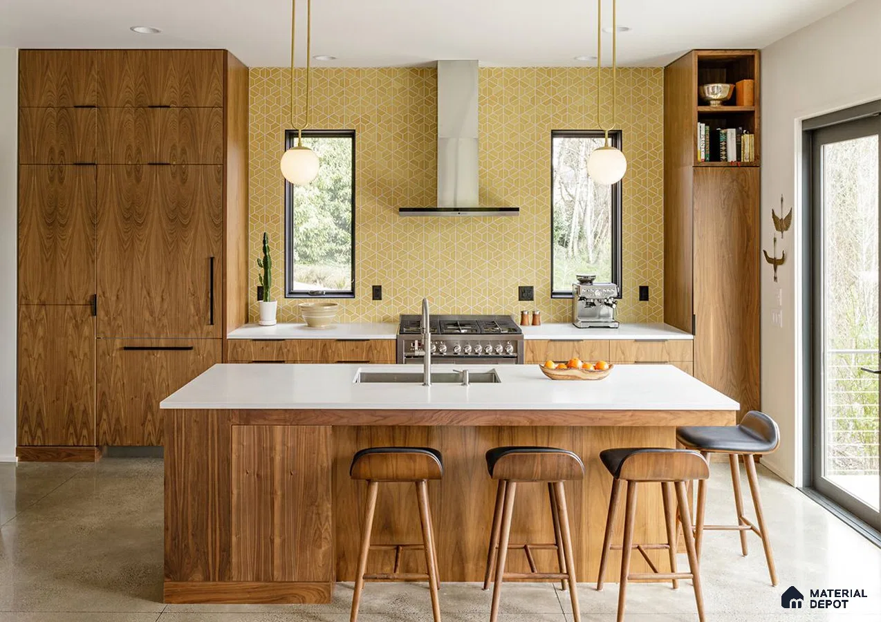 A kitchen with wooden cabinets and white counter tops, along with an island in the middle of the middle of the room with wood flooring and white cabinets and white counter tops is lit by recessed lighting hanging from